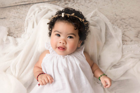 6 month baby in white at June Bug Photography studio in Mill Creek