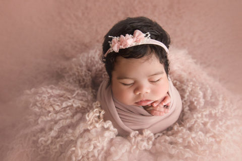 Newborn baby on pink fur