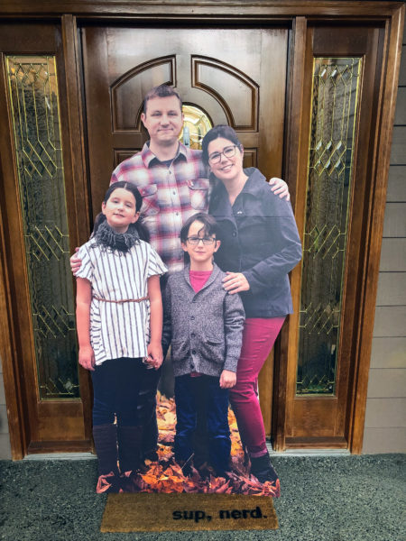 cardboard stand up print of a family on a front porch